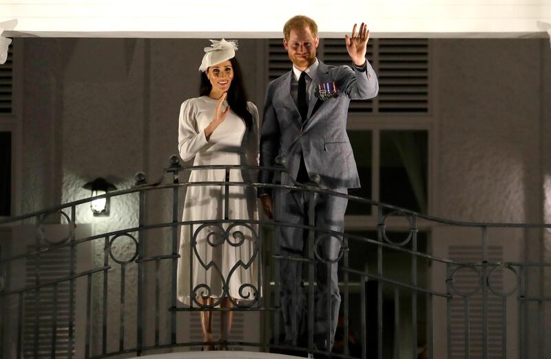 Britain's Prince Harry and Meghan, Duchess of Sussex wave from a balcony as they arrive for an official dinner in Suva, Fiji, Tuesday, Oct. 23, 2018. Prince Harry and his wife Meghan are on day eight of their 16-day tour of Australia and the South Pacific.(AP Photo/Kirsty Wigglesworth)