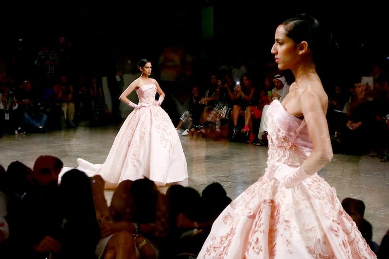 Ball gowns on the runway at an Ezra Santos show at Dubai's Fashion Forward. Getty Images 