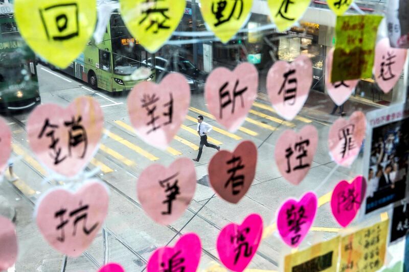 HONG KONG: ART FEATURE:
Pictured: A man runs past post-it notes which form part of a Lennon Wall in Central Hong Kong. Lennon Walls are area designated to posters, art and messages in support of the pro-democracy movement. 