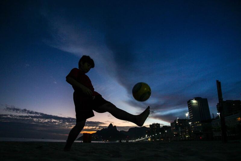 A child plays football at Ipanema beach in Rio de Janeiro, Brazil. The 2014 Fifa World Cup starts on 12 June. Antonio Lacerda / EPA