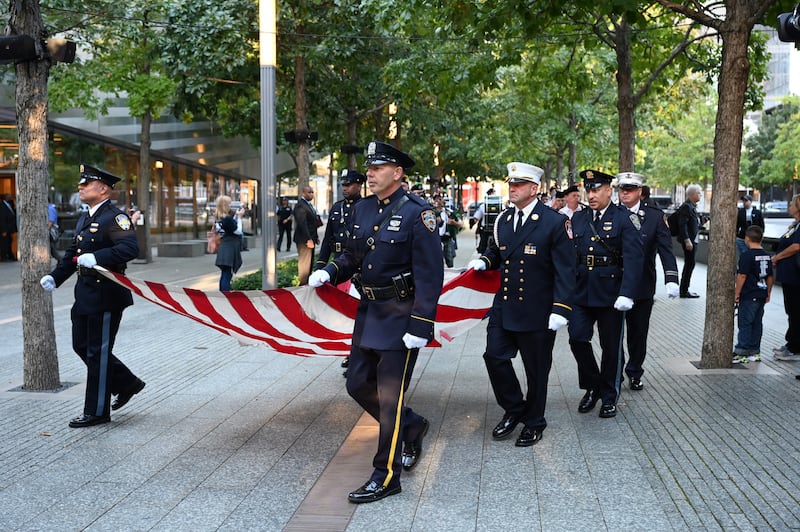 A NYPD Honor Guard marches in with a damaged American Flag at the South Tower before ceremonies marking the 20th anniversary of the 9. 11 attack at the World Trade Center in New York which killed almost 3,000 people.   EPA