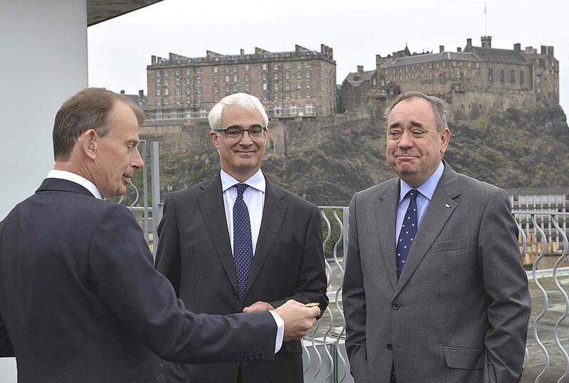 Alistair Darling, centre, the leader of the campaign to keep Scotland part of the United Kingdom, and Scottish first minister Alex Salmond, right, watch as Andrew Marr prepares to toss a coin on the BBC's Andrew Marr Show in Edinburgh. Jeff Overs / BBC / Handout via Reuters 