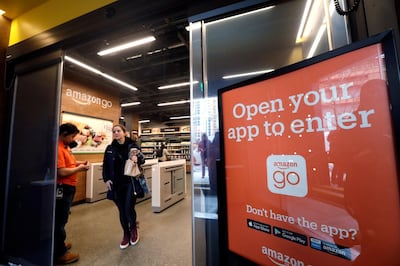 FILE- In this Jan. 22, 2018, file photo, a shopper departs an Amazon Go store in Seattle. Get ready to say good riddance to the checkout line. A year after Amazon opened its first cashier-less store, startups and retailers are racing to get similar technology in other stores throughout the world, letting shoppers buy groceries without waiting in line. (AP Photo/Elaine Thompson, File)