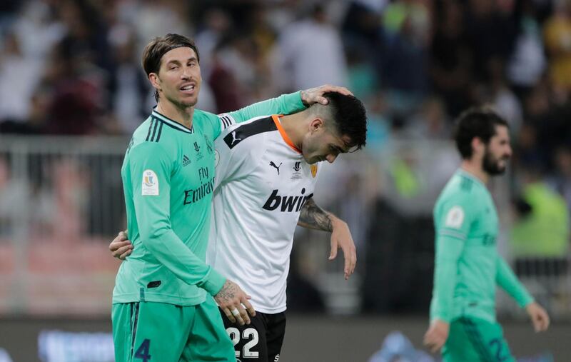 Real Madrid's Sergio Ramos, left, comforts Valencia's Maxi Gomez. AP