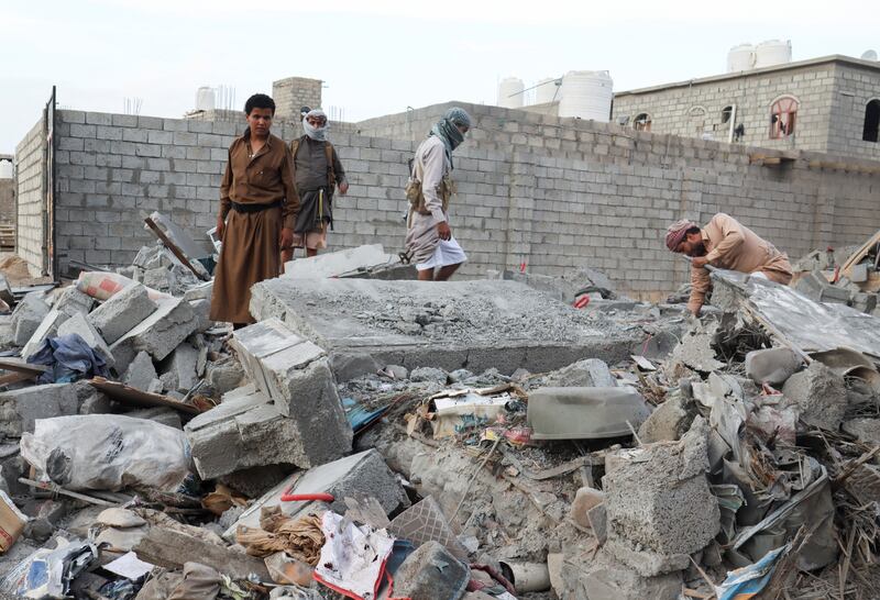 People scan the rubble of a house destroyed by Houthi missile attack in the northern Yemeni city of Marib. Reuters