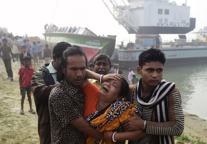 Grieving friends and relatives of those who died in a ferry accident on Sunday at Padma river in Bangladesh. The death toll rose toat least 69 on Monday when the ferry was lifted from the water. Munir uz Zaman/AFP Photo

