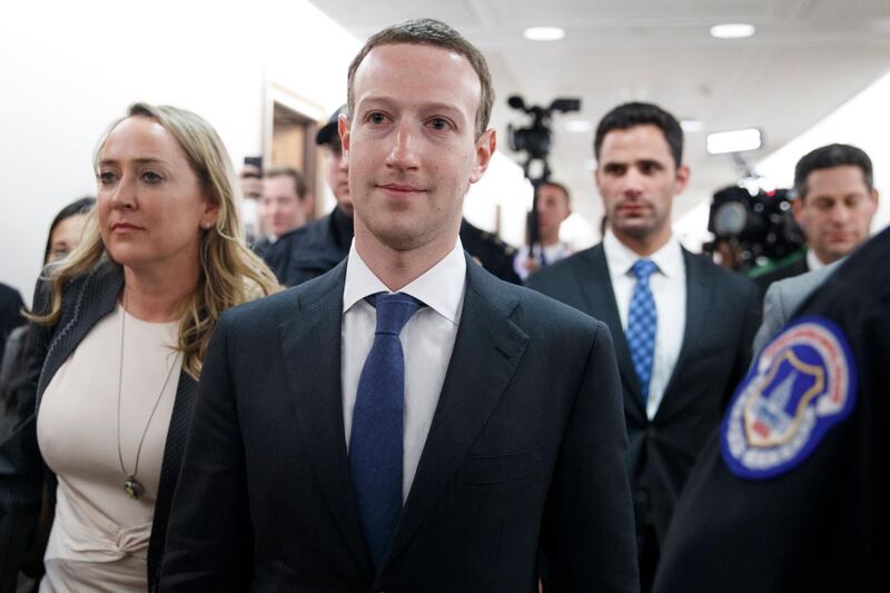 epa06657950 CEO of Facebook Mark Zuckerberg (C) walks to the office of Republican Senator from South Dakota John Thune for a meting on Capitol Hill in Washington, DC, USA, 09 April 2018. Zuckerberg is meeting with lawmakers before testifying in two Congressional hearings this week regarding Facebook allowing third-party applications to collect the data of its users without their permission, and for the company's response to Russian interference in the 2016 US presidential election.  EPA/SHAWN THEW