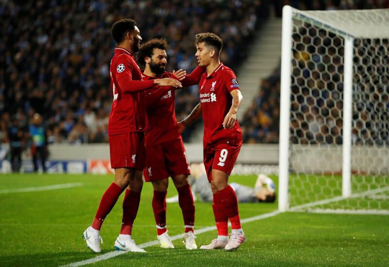 Roberto Firmino and Joe Gomez congratulate Salah. Andrew Boyers / Reuters