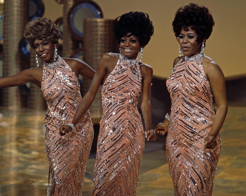 The Supremes (Cindy Birdsong, Diana Ross and Mary Wilson), wearing matching sequinned peach dresses with silver necklaces and earrings, during a live concert performance, circa 1965. (Photo by Silver Screen Collection/Getty Images)