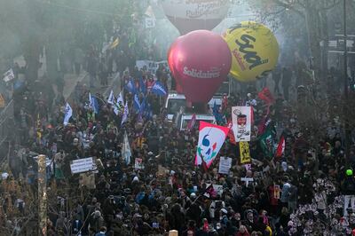 Demonstrators march during the protest in Paris.  AP
