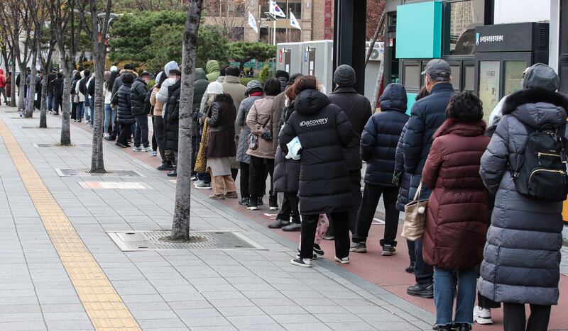 People queue outside a Covid-19 testing centre in Seoul's south-eastern district of Songpa. EPA