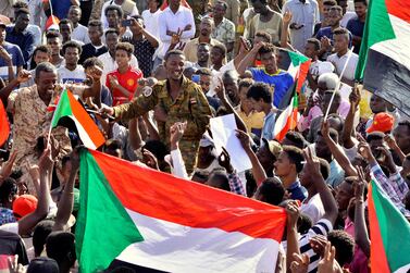 Sudanese military officer joins demonstrators as they celebrate Defence Minister Awad Ibn Auf stepping down as head of the country's transitional ruling military council. Reuters