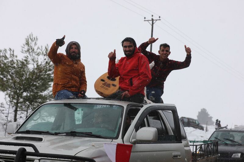 Musicians drive through the snow.