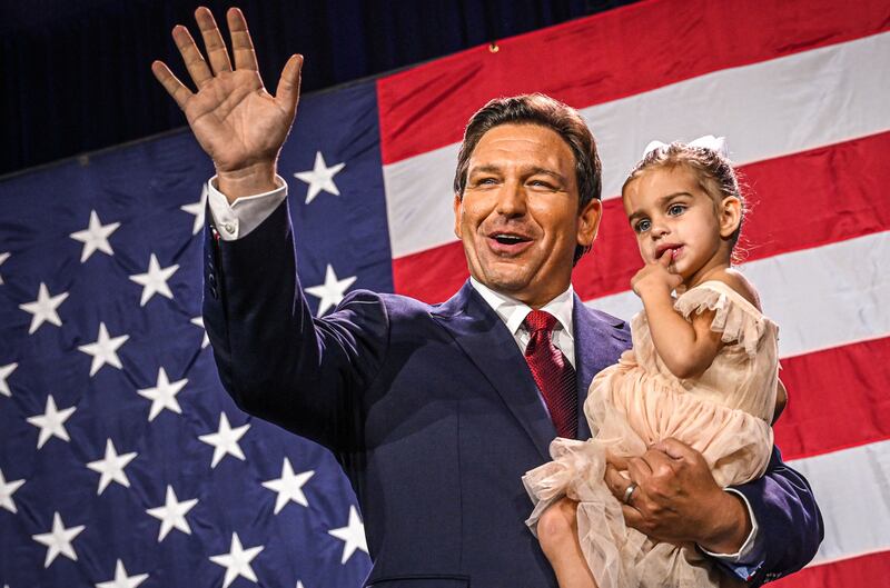 Florida Governor Ron DeSantis holds his daughter during an election night watch party in November 2022. AFP
