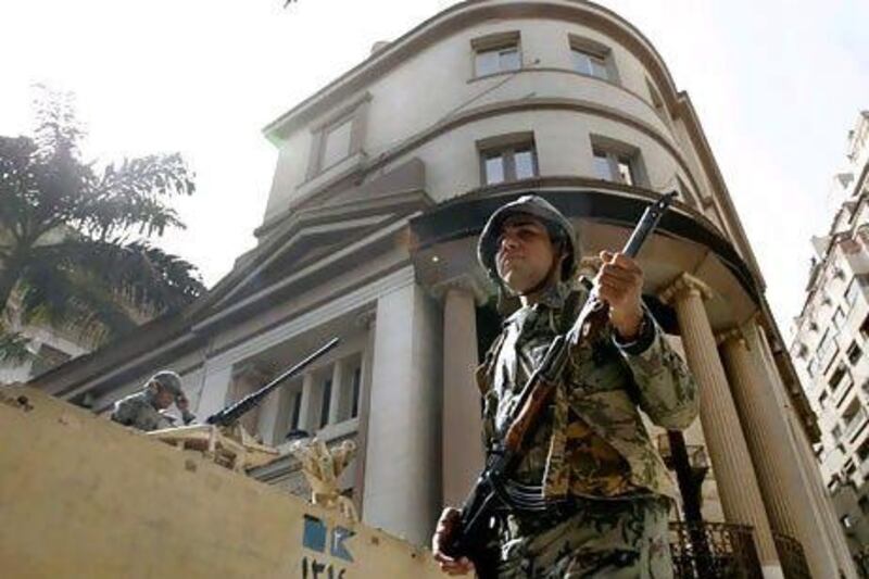 Soldiers guard the Cairo stock exchange, which has been closed for a month. The bourse will reopen today.