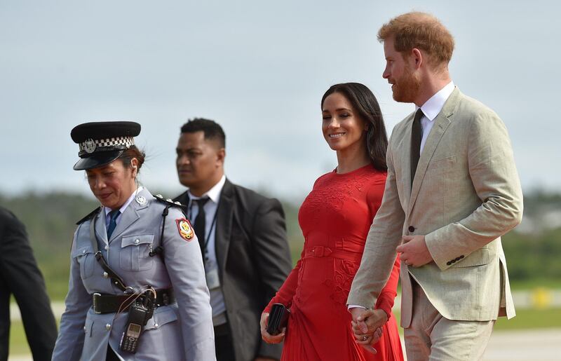 Britain's Prince Harry and his wife Meghan Markle, the Duchess of Sussex arrive at Fua'amotu airport in Tonga.. AFP