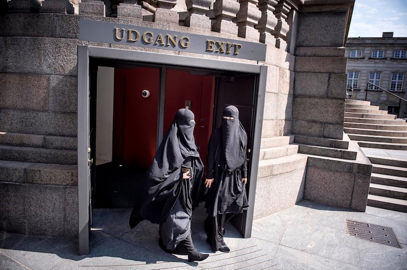 Women wearing the islamic veil niqab walk out of the exit doors of the Danish Parliament, at Christiansborg Castle, in Copenhagen, Denmark, Thursday May 31. 2018. Denmark joined some other European countries in deciding Thursday to ban garments that cover the face, including Islamic veils such as the niqab or burqa. (Mads Claus Rasmussen/Ritzau Scanpix via AP)