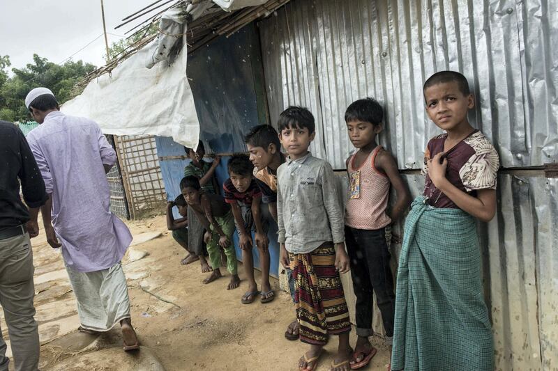 Rohingya children take shelter from the rain in the refugee camp near Cox's Bazar, Bangladesh, on August 13 2018. Campbell MacDiarmid for The National