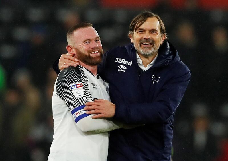 Derby County manager Phillip Cocu celebrates with Wayne Rooney after the victory against Barnsley on Thursday. Reuters