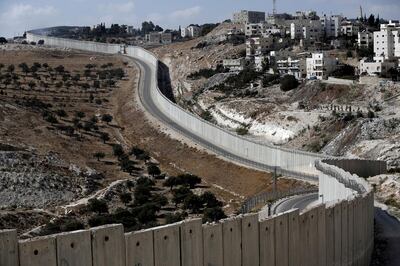 The Palestinian  city of Abu Dis is seen near the Israeli separation barrier in the West Bank. Ahmad Gharabli / AFP Photo  