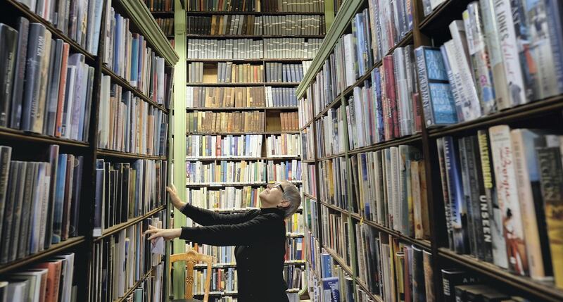 LEEDS, ENGLAND - JANUARY 09: Library member Diane English looks for a book inside the Leeds Library on January 9, 2018 in Leeds, England. This year sees the 250th anniversary of the oldest subscription library in the United Kingdom. Founded in 1768 the Grade II listed building in the heart of Leeds is the the oldest surviving example of this sort of library in the country. It holds over 140,000 thousand books and has 880 members. To mark the anniversary there are a range of events planned throughout the year. (Photo by Ian Forsyth/Getty Images)