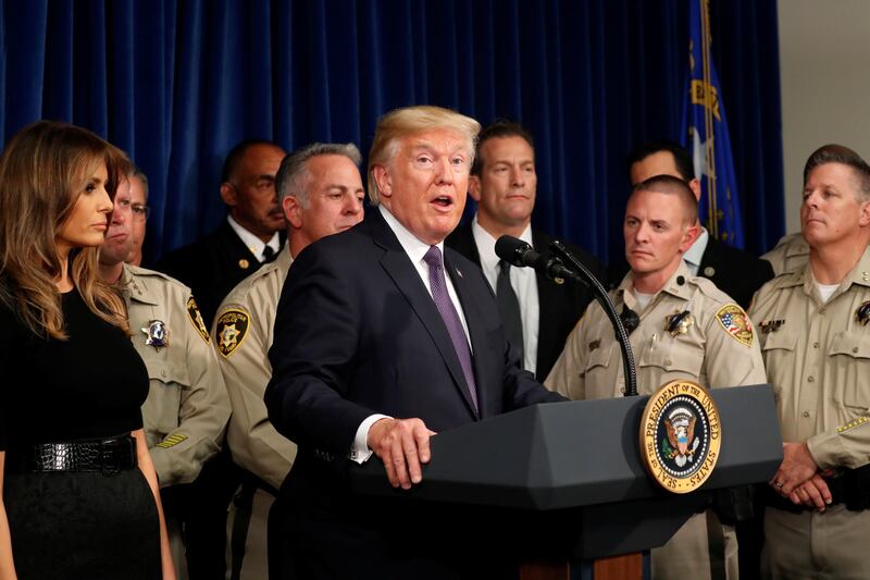US President Donald Trump speaks next to first lady Melania Trump after meeting with police at the Las Vegas Metropolitan Police Department in the wake of the mass shooting in Las Vegas. Kevin Lamarque / Reuters