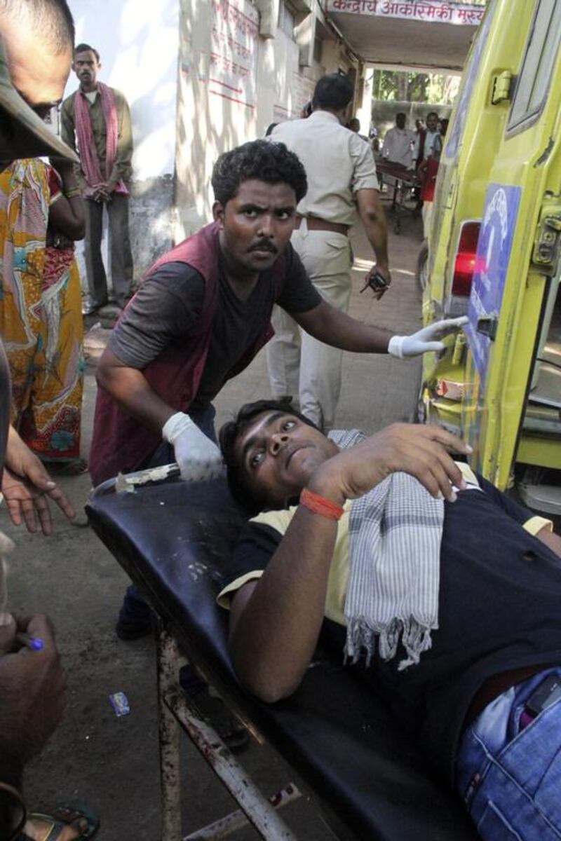 A man injured in a bombing is taken for treatment at the government medical college hospital in Patna. Aftab Alam Siddiqui / AP