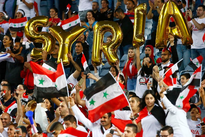 Syria fans cheer on their team from the stands. David Gray / Reuters