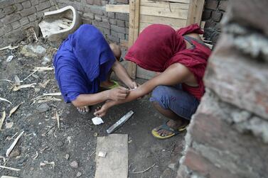 Young Indian drug addicts use heroin in an abandoned building in the Punjab city of Jalandhar in this June 15, 2016 picture. Shammi Mehra / AFP