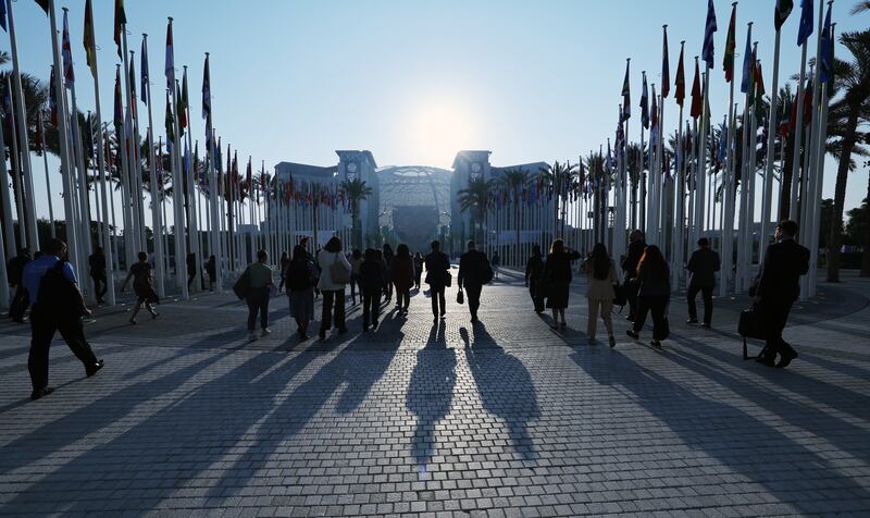 People arrive for the fourth day of the Cop28 summit at Expo City Dubai. EPA