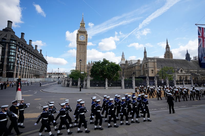 Royal Navy soldiers march ahead of the procession near Big Ben. Getty