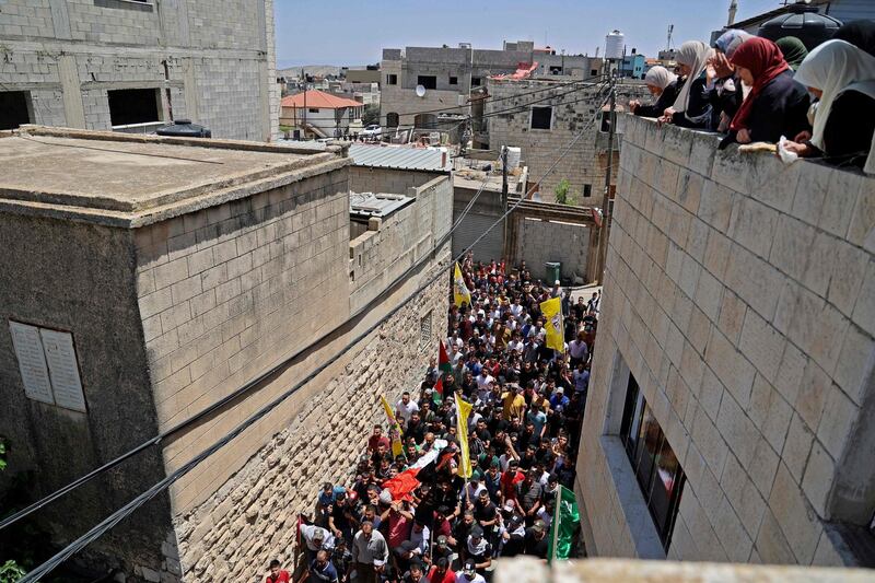 Mourners attend the funeral of Palestinian Rashid Abu Ara, 16, who was killed during clashes with Israeli troops in village of Aqaba near Nablus, north of the West Bank. AFP