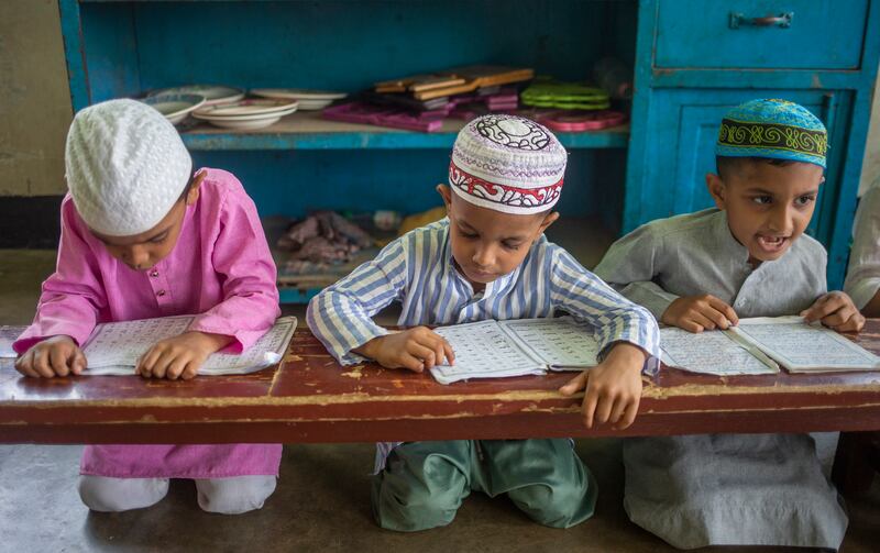 Bangladeshi Muslim students read the Quran in Dhaka, Bangladesh. EPA