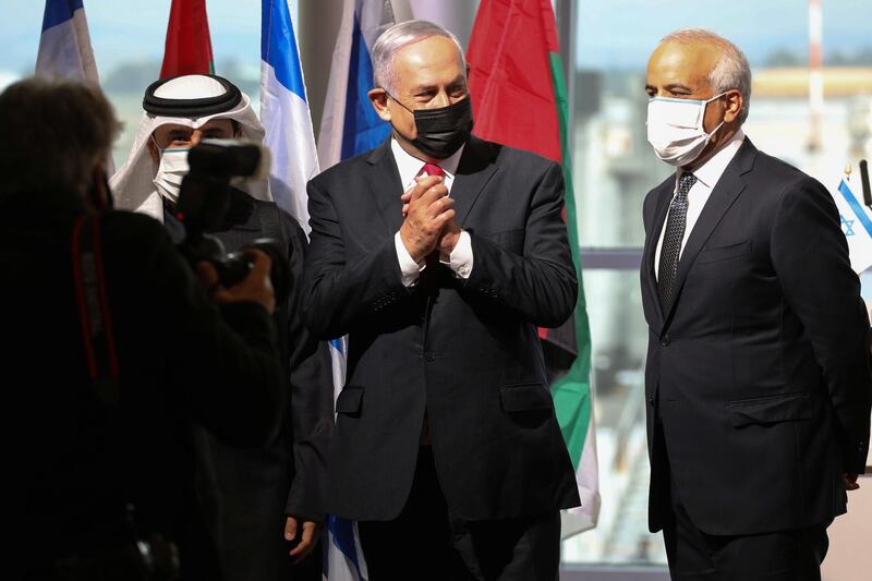 Israeli Prime Minister Benjamin Netanyahu gestures during a welcoming ceremony upon the landing of a flydubai flight at Ben Gurion International Airport, near Tel Aviv, Israel on November 26, 2020. REUTERS/Emil Salman/Pool
