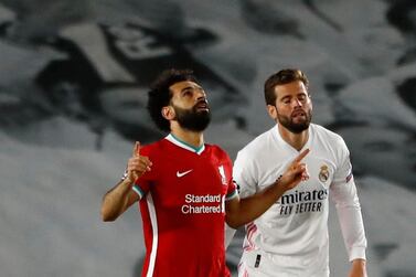 Soccer Football - Champions League - Quarter Final - First Leg - Real Madrid v Liverpool - Estadio Alfredo Di Stefano, Madrid, Spain - April 6, 2021 Liverpool's Mohamed Salah celebrates scoring their first goal with teammates REUTERS/Susana Vera