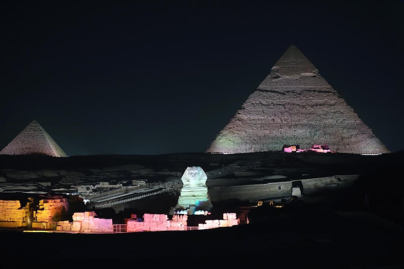 The Sphnix is lit up in front of the Great Pyramids during the Sound and Light show at the Giza Pyramids plateau, in Giza, Egypt. EPA