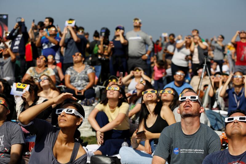 People watch the solar eclipse on the lawn of Griffith Observatory in Los Angeles, California. Mario Anzuoni / Reuters