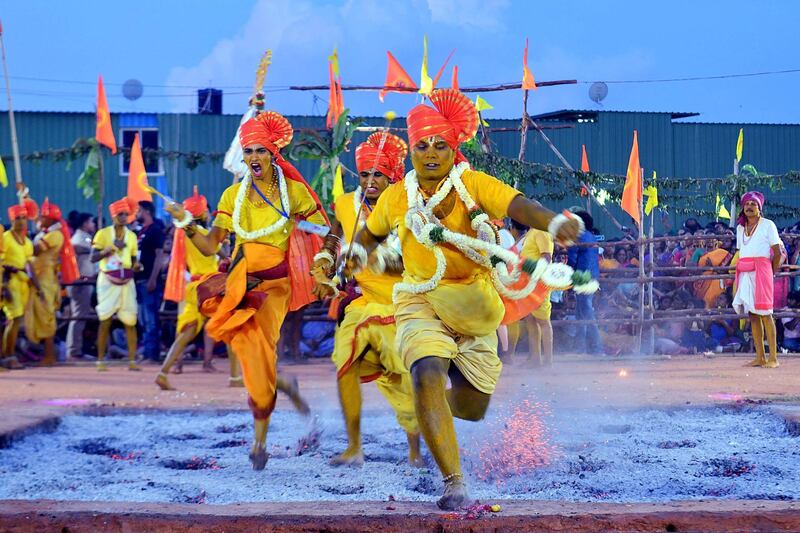 Hindus run through red hot embers as part of annual fire walking ritual during 'Draupadi Amman' festival in Bangalore. AFP