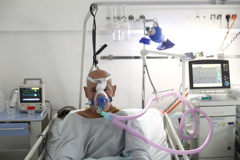 A patient breathes through an oxygen mask at the Covid-19 ICU unit of the Dr Abdulah Nakas General Hospital in Sarajevo, Bosnia.  AP