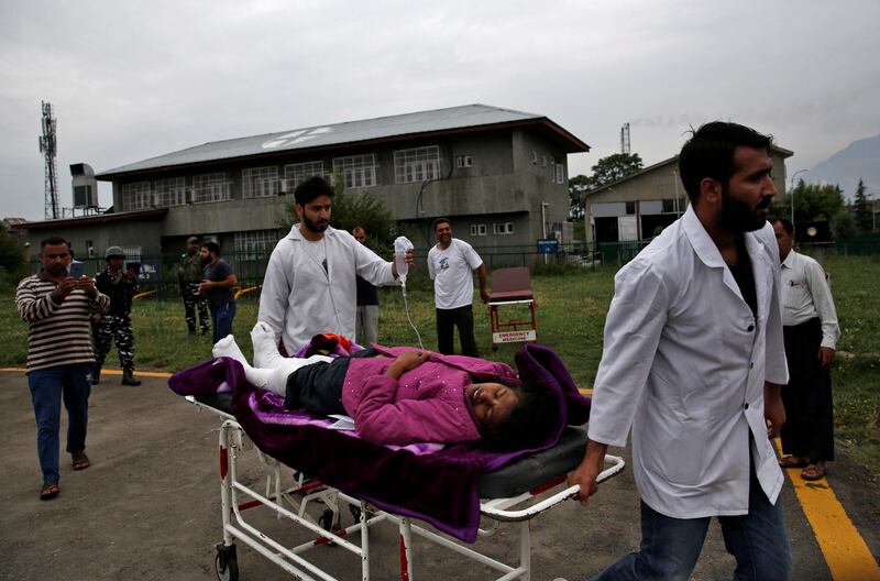 An injured woman is taken for treatment. Reuters / Danish Ismail