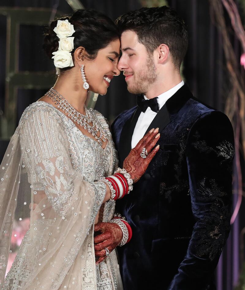 Newlyweds Priyanka Chopra, 36, and Nick Jonas, 26, pose for a photograph during a reception at a hotel in New Delhi on December 4, 2018. Photo: EPA