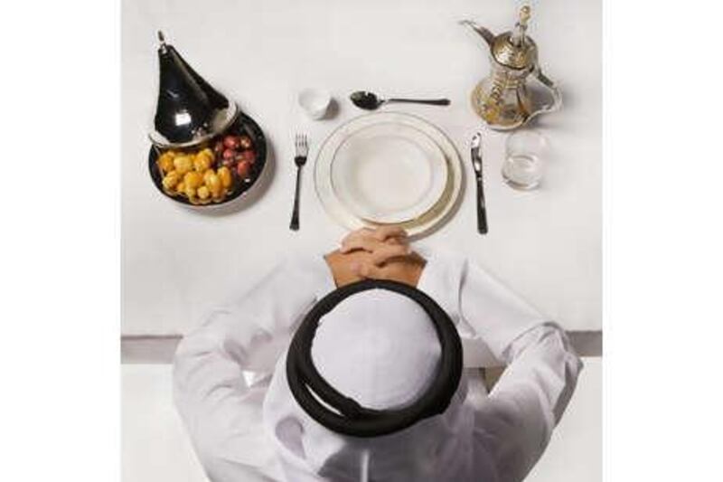 A man prays before breaking his fast. Typically, the Ramadan fast is broken with water and dates before a feast of traditional food is served.