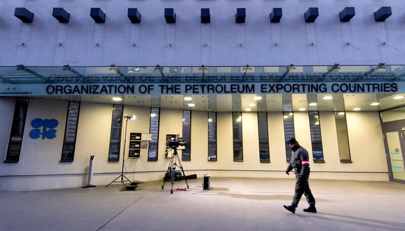 An Austrian soldier stands guard outside the OPEC headquarters last year.  IEA said Thursday OPEC adherence to oil output cut sinks to six-month low. JOE KLAMAR/AFP