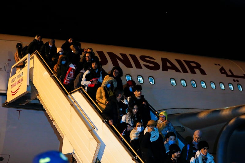 Tunisians leaving a plane upon their arrival at the airport. Reuters