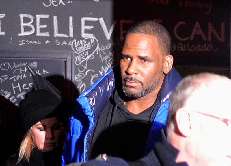 Musician R. Kelly leaves his Chicago studio Friday night, Feb. 22, 2019, on his way to surrender to police. R&B star Kelly was taken into custody after arriving Friday night at a Chicago police precinct, hours after authorities announced multiple charges of aggravated sexual abuse involving four victims, including at least three between the ages of 13 and 17.  (Victor Hilitski/Chicago Sun-Times via AP)