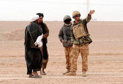 Prince Harry directs two Afghan men around a British Army cordon, with the help of an Afghan interpreter in Helmand province in 2008. A total of 2,300 interpreters have now been removed from the country by Britain.  Reuters