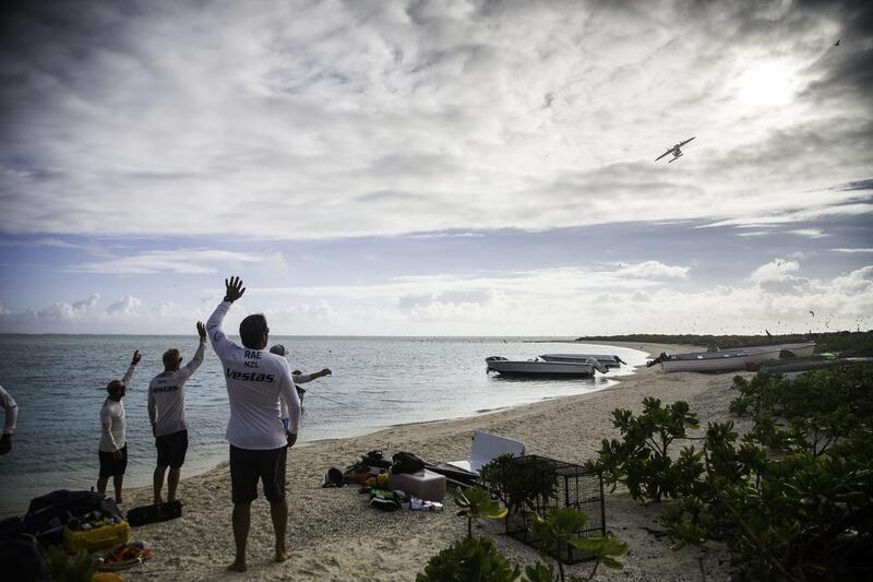 The crew of Team Vestas Wind wave to a plane after it dropped off supplies on Ile Du Sud, Mauritius, following the grounding of their boat on a nearby reef. The accident ended the second leg of the Volvo Ocean Race for the crew, who are optimistic that they can return. Courtesy VOR

