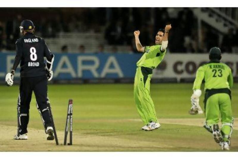 Pakistan's Umar Gul, right, celebrates bowling England's Stuart Broad for two and winning the fourth one-day international in England in 2010.
