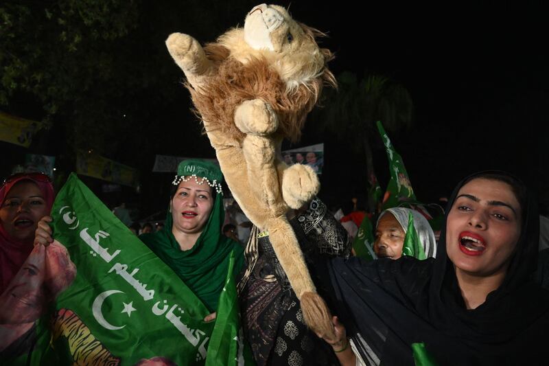 A supporter of Shahbaz Sharif holds a toy lion. His party, PML-N, has a tiger as its mascot. AFP