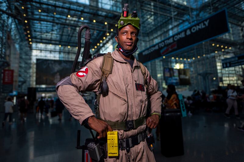 An attendee dressed as a Ghostbuster poses during New York Comic Con. Charles Sykes / Invision / AP